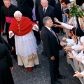 Pope Benedict XVI waves to the crowd after celebrating an early morning Mass at the Church of St. Thomas Aug. 15, the feast of the Assumption of Mary, at his summer residence in Castel Gandolfo, Italy, Aug. 14.