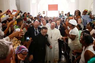 Pope Francis greets people as he arrives to visit the Shrine of St. Peter Claver in Cartagena, Colombia, Sept. 10.