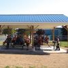 Students from St. Mary’s Catholic Elementary School seek shelter from the afternoon sun under their new outdoor learning pavilion.