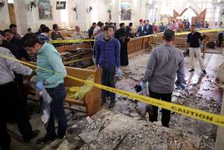 Security personnel investigate the scene of a bomb explosion April 9 inside the Orthodox Church of St. George in Tanta, Egypt April, 9.