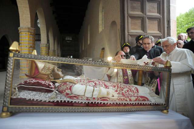 Pope Benedict XVI places a white stole on the remains of St. Celestine V, a 13th-century pope, during his 2009 visit to the earthquake-damaged Basilica of Santa Maria di Collemaggio in L&#039;Aquila, Italy. St. Celestine was the last pope to voluntarily resig n before Pope Benedict stepped down in February 2013. Pope Francis has said Pope Benedict&#039;s resignation has opened the door to the possibility of future popes stepping down from their position. (
