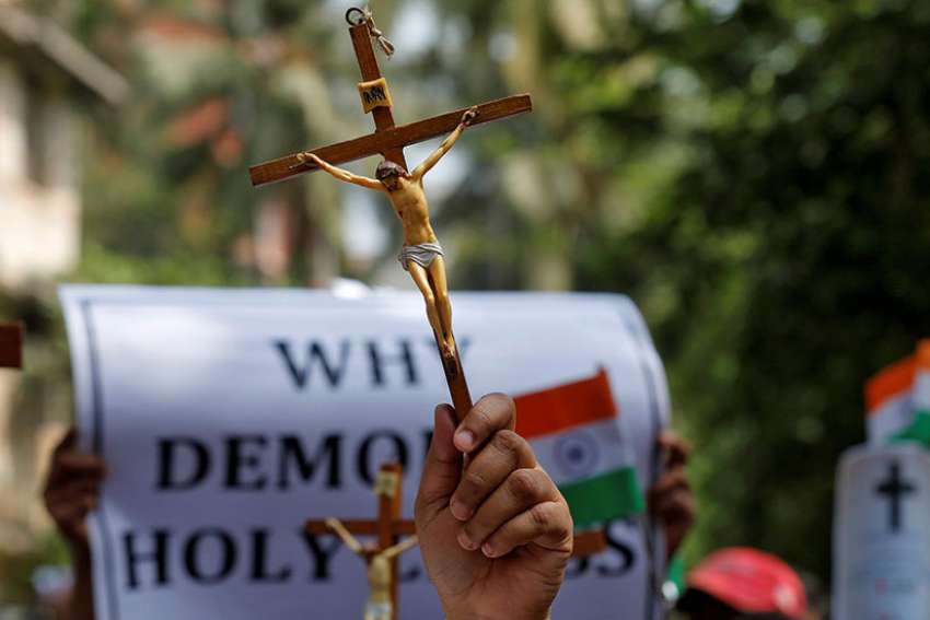 A woman holds a cross during a May 3 protest in Mumbai, India, organized by various Catholic organizations against what they say is an illegal demolition of a cross by a municipal body. 