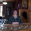 Beverly Delormier behind the counter at the gift shop at St. Francis Xavier Mission in Kahnawake, Que.