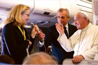 Pope Francis reacts to questions from Associated Press reporter Nicole Winfield about the September U.S. papal visit during a news conference aboard his flight from Manila, Philippines, to Rome Jan. 19.