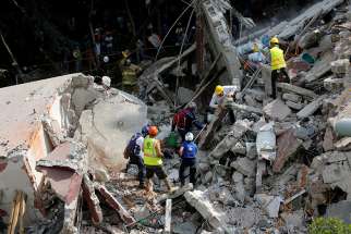 Rescue personnel remove rubble Sept. 20 at a collapsed building while searching for survivors after an earthquake hit Mexico City. The magnitude 7.1 earthquake hit Sept. 19 to the southeast of the city, killing hundreds. 