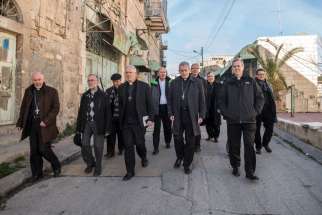 Bishops from the U.S, Canada and Europe walk through a street Jan. 16 in Hebron, West Bank.