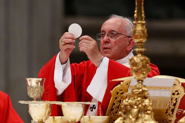 Pope Francis elevates the Eucharist during a Mass marking the feast of Sts. Peter and Paul in St. Peter&#039;s Basilica at the Vatican June 29. 