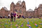 We Need A Law campaign director Mike Schouten and media relations assistant Niki Pennings on the lawn of Queen’s Park, where the campaign arranged a display of 100,000 pink and blue flags to represent abortions performed in Canada each year. 