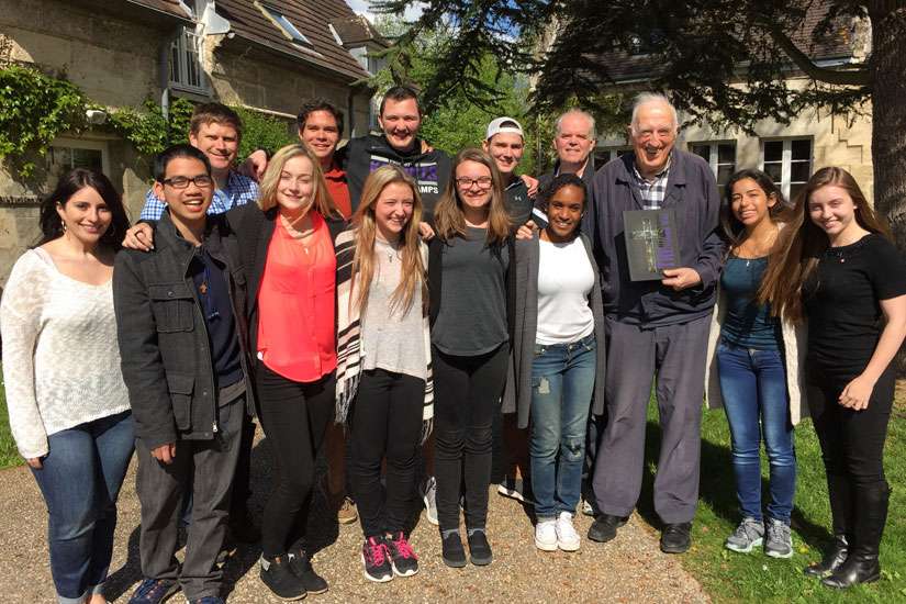 A Jean Vanier Catholic Secondary School delegation poses with the school’s namesake in front of the L’Arche centre.