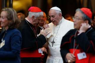 Pope Francis talks with Cardinal Giuseppe Versaldi following the concluding session of the extraordinary Synod of Bishops on the family at the Vatican in this Oct. 18, 2014, file photo.