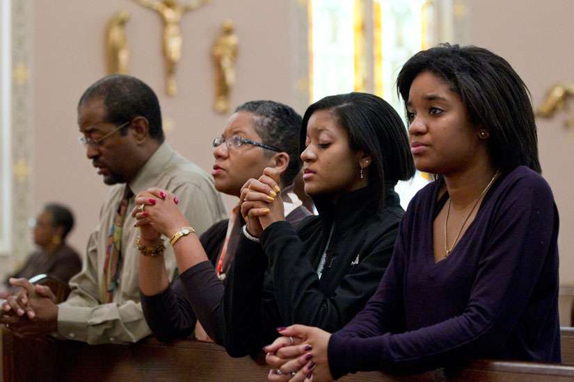 A family prays after arriving for Sunday Mass in 2011 at St. Joseph&#039;s Catholic Church in Alexandria, Va.