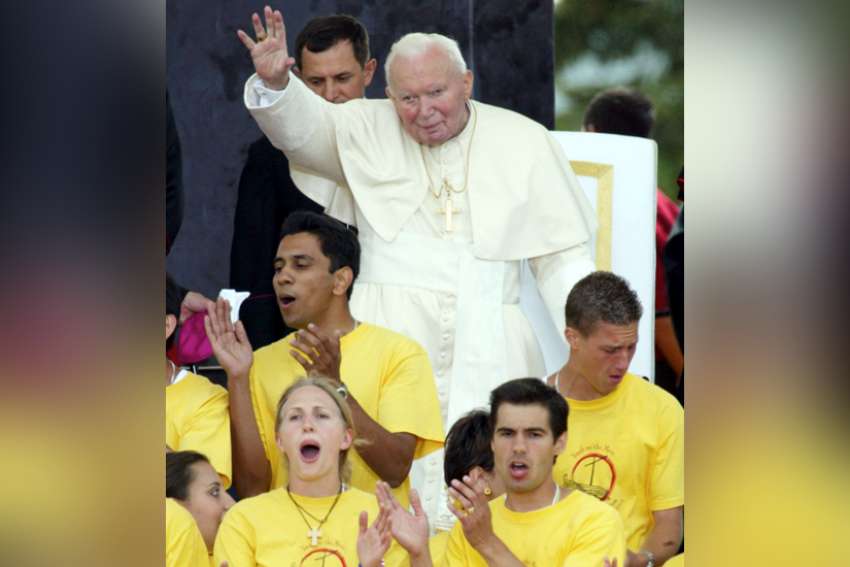 Pope John Paul II greets cheering pilgrims at World Youth Day in Toronto July 25. The pontiff was clearly energized by the enthusiasm of the crowd during his first meeting with the youths.