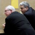 Msgr. William Lynn, left, leans on a counter before entering the courthouse for the opening day of his trial in Philadelphia March 26. Msgr. Lynn being tried on charges of having failed to protect children from two priest-abusers who were under his direc tion when he served as secretary of the clergy for the Philadelphia Archdiocese from 1992 to 2004.