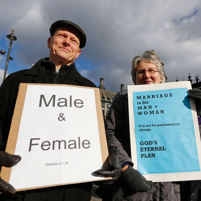 Christian activists Jonathan Longstaff and Jenny Rose, both from London, protest outside Parliament before a vote on same-sex marriage in London Feb. 5. British Prime Minister David Cameron is expected to see his ruling Conservative party split in two on Tuesday over his government&#039;s plans to legalize same-sex marriage.