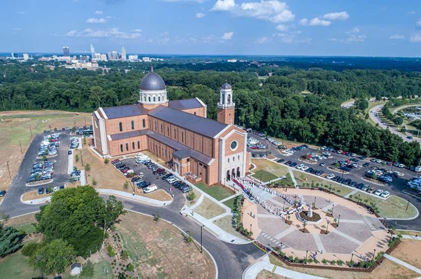 Priests gather outside Holy Name of Jesus Cathedral immediately after Mass July 26 at the dedication for the cathedral in Raleigh, N.C.