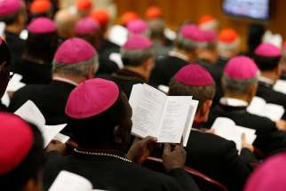 Bishops pray at the start of a session of the Synod of Bishops on young people, the faith and vocational discernment at the Vatican Oct. 9. 