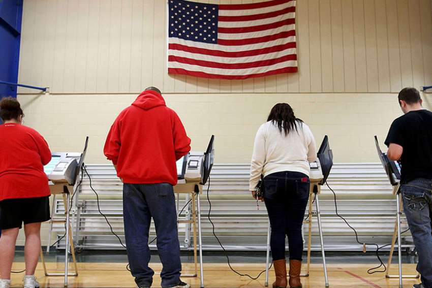 Voters cast their votes during the presidential election in Elyria, Ohio, on Nov. 8, 2016. Preliminary exit polls indicate that white Catholics, evangelical and Mormon vote voted for Trump in wide margins.