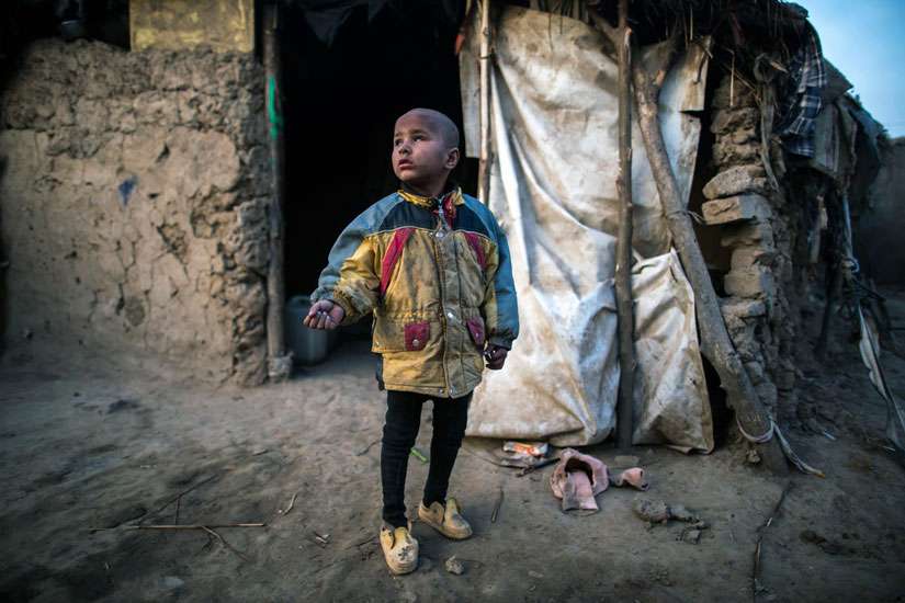 A blind boy stands outside his makeshift shelter in Islamabad. Pope Francis urged world leaders at G-20 to focus on helping the poor and “not to forget that many lives are at stake.”