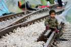 A child sits on railroad tracks near a makeshift camp for migrants in late March at the Greek-Macedonian border near the village of in Idomeni, Greece. Children are the most vulnerable and hardest hit among the world&#039;s migrants and require special protection, Pope Francis said.