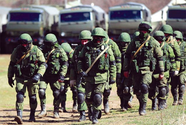 Armed men, believed to be Russian soldiers, march at their camp near the Ukrainian military base in Perevalnoye outside Simferopol, Ukraine, March 17. Canadian Jesuit Father David Nazar was at the EU April 1 to make the case for the revolution in Ukraine.