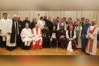 Participants at last year’s GTA prayer service for the Week of Prayer for Christian Unity, including Cardinal Thomas Collins, seated second from the left, pose for a photo.