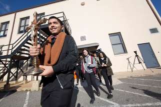 Christopher Hernandez, a senior at Don Bosco Cristo Rey High School in Takoma Park, Md., leads students as they exit the school to participate in the National School Walkout March 14. During the walkout students prayed 17 Hail Marys and released 17 balloons, one for each of the people killed in a Feb. 14 school shooting in Parkland, Fla.