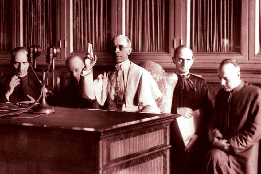 Pope Pius XII, head of the Church from 1939-58, gives a blessing at the end of a radio message Sept. 1, 1943.