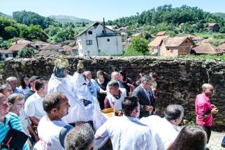 Priests carry the statue of the Black Madonna during a procession around the Church of the Black Madonna to celebrate the Feast of the Assumption of Mary on Aug. 15, 2016, in Letnica, Kosovo.