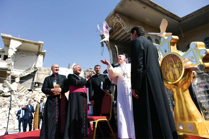 Pope Francis releases a white dove during a memorial prayer for the victims of the war at Hosh al-Bieaa (church square) in Mosul, Iraq, in this March 7, 2021, file photo. Being against war demands courageous craftsmanship, the Pope wrote in the forward to a new book.