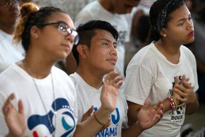Yassiel Barranco, 21, Ivan Lopez, 20, and Liz Marie, 17, pray during a vigil for young people at the Church of Christ the Redeemer April 22 outside Panama City. World Youth Day 2019 will be celebrated Jan. 22-27 in Panama City. 