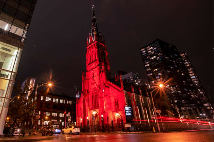 St. Michael’s Cathedral Basilica in Toronto illuminated in red lights for Red Wednesday.