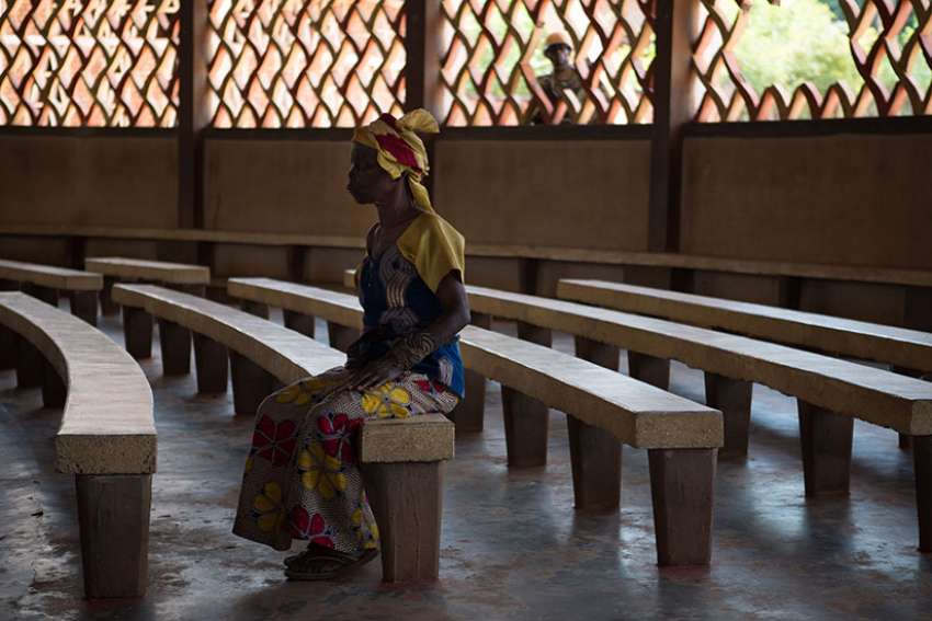 A woman sits in St. Joseph Cathedral in Bambari, Central African Republic, in this 2014 file photo. A Catholic Relief Services official says the situation in the Central African Republic is worsening, as church centers are attacked and more armed groups fight over territory and resources.