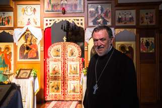 Father Lawrence Cross stands in front of the iconostasis in the Russian Catholic Church of St. Nicholas in the Melbourne suburb of St. Kilda. A global congress of Russian Catholics meeting in Italy in June and organized by Father Cross hopes to revive their tiny church as an exarchate.