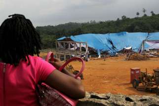 A woman seeking her loved ones is seen at the venue of the collapsed church building in Uyo, Nigeria December 11, 2016.