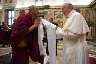 Pope Francis greets a Buddhist monk during a Nov. 3, 2016 audience with religious leaders at the Vatican.