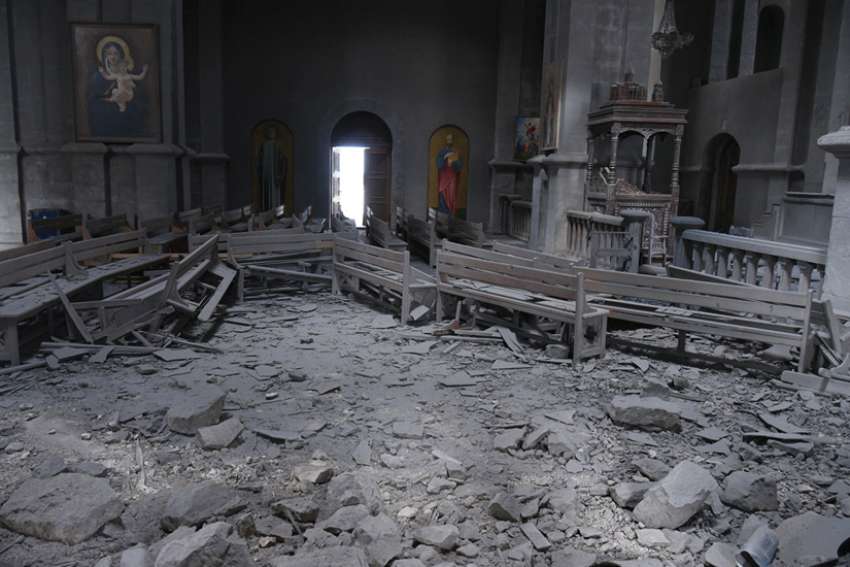 Damaged pews lie amid rubble inside Holy Saviour Cathedral in Shusha, Azerbaijan, after shelling.