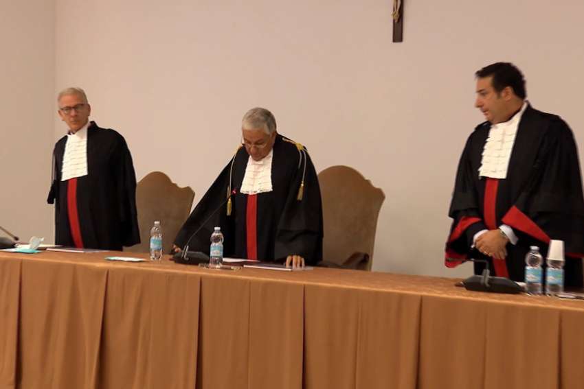 Vatican Court President Giuseppe Pignatone speaks during the verdict of Father Gabriele Martinelli and Msgr. Enrico Radice in this still image taken from video Oct. 6, 2021. The two clergymen, who were accused of sexually abusing a younger student at St. Pius X Pre-Seminary between 2007 and 2012, were cleared of the charges.