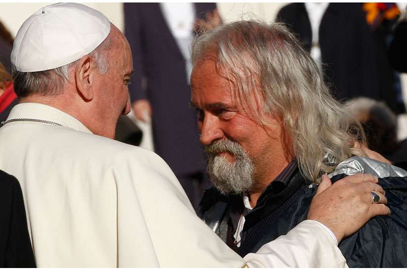 Pope Francis greets one of eight poor people at his general audience in St. Peter&#039;s Square at the Vatican Dec. 17, the pope&#039;s 78th birthday. A group of the poor were invited to the audience in celebration of the pope&#039;s birthday. 