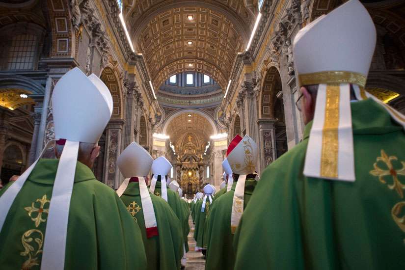 Bishops arrive in procession for the opening Mass of the Synod of Bishops on the family in St. Peter&#039;s Basilica at the Vatican Oct. 4.