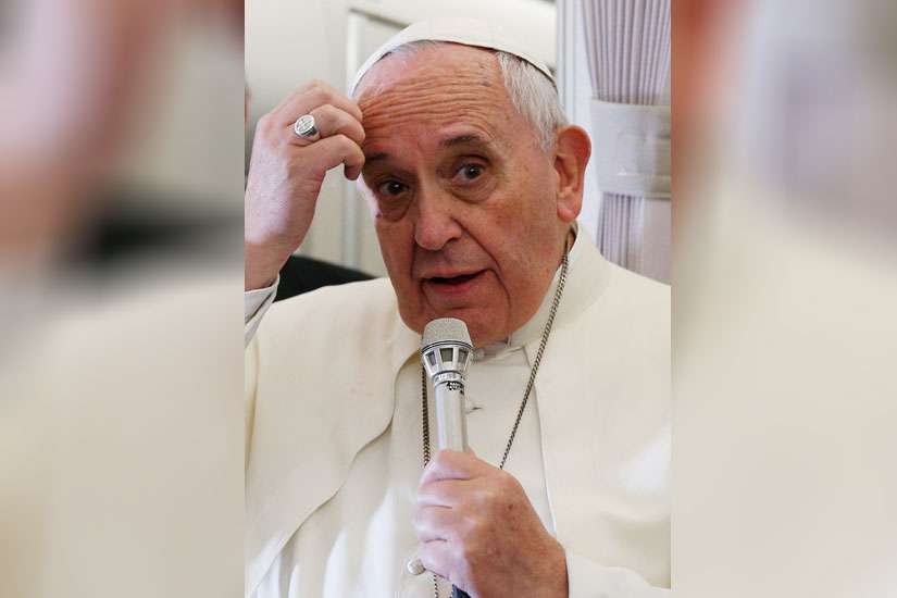 Pope Francis answers questions from journalists aboard his flight from Manila, Philippines, to Rome Jan. 19.