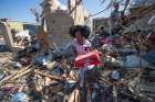 A family recovers belongings from their destroyed home in Rolling Fork, Miss., March 26, 2023, after a tornado swept through the town. At least 25 people were killed and dozens of others were injured in Mississippi as the massive storm ripped through more than a half-dozen towns late March 24.