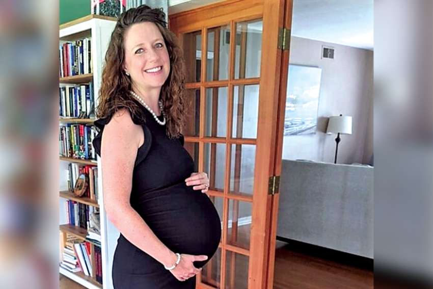 Stephanie Gray Connors, author of Conceived by Science: Thinking Carefully and Compassionately about Infertility and IVF. The photo was taken when she was seven months’ pregnant with her daughter, who is now six months old.