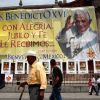 People walk past a banner welcoming Pope Benedict XVI outside the Basilica of Our Lady of Guadalupe in Mexico City March 19. The pope will arrive in Leon, Mexico, March 23 to begin his six-day visit to Mexico and Cuba.