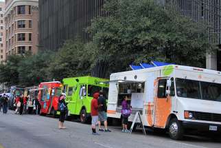 Food trucks seen in Austin, Texas in 2014. Mobile Loaves and Fishes is a Christian non-profit founded by Graham and five other men that delivers about 1,200 meals and essentials from 12 food trucks to homeless people on the streets of Austin every night.