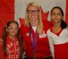 After reading their letter of thanks to Canadian Olympian Melanie Booth (centre), Debbie Dias (left) and Vanessa Ferreira pose with the Olympic bronze medalist.