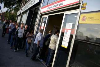 eople enter a government-run employment office in Madrid. 