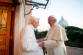 Retired Pope Benedict XVI greets Pope Francis at the Mater Ecclesiae monastery at the Vatican Dec. 23, 2013.