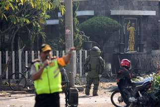 A member of the police bomb squad unit examines the site of a May 12, 2018, explosion outside Santa Maria Catholic Church in Surabaya, Indonesia. The U.S. State Department&#039;s newly released annual report on international religious freedom shows continued attacks and abuse by governments and societies against religious minorities in their respective countries.