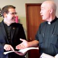 Deacon Matthew Hysell (left), who will be ordained a priest Dec. 7, discusses a point with Fr. Jim Corrigan, pastor of Edmonton’s St. Theresa parish.