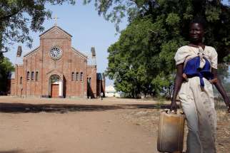 A young woman is pictured in a file photo near a church in Rajaf, South Sudan. The murder of three young girls in South Sudan&#039;s capital, Juba, has generated response from Catholic leaders and united the entire country.